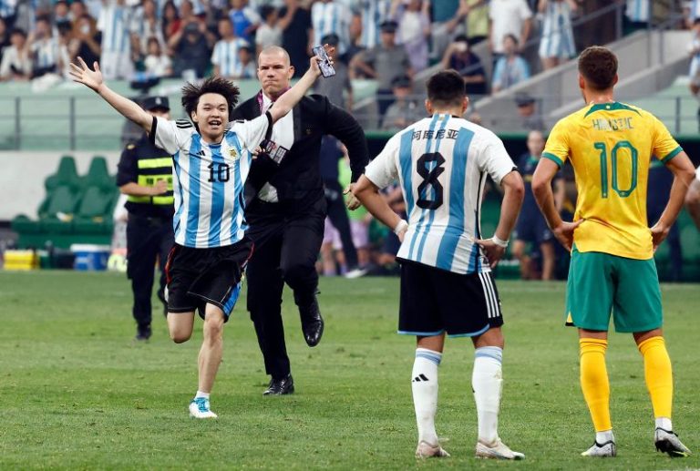 Young Chinese soccer fan gives security the slip to hug his hero Messi mid-game