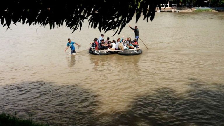 Families board makeshift rafts to get closer to the US