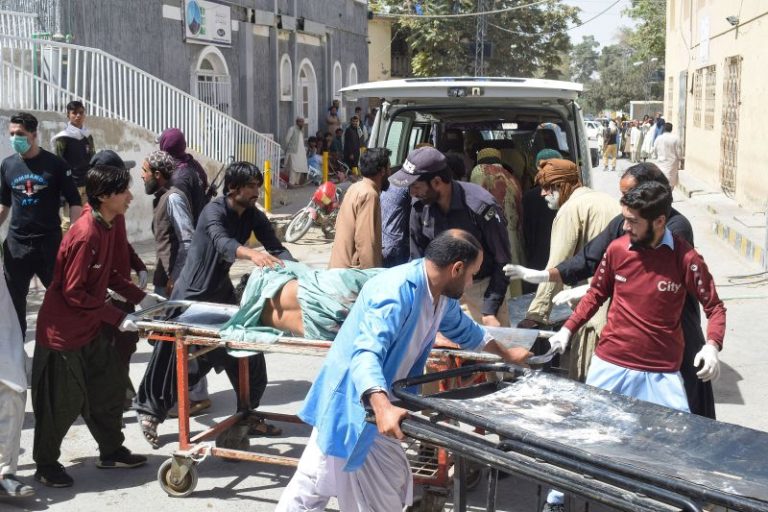 At least 56 killed after suicide bombings rip through two religious ceremonies in Pakistan