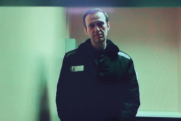 Jailed Kremlin critic Navalny makes first court appearance from Siberian penal colony