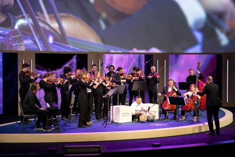 A conductor invited refugees who’d never played instruments to join his orchestra. It changed his life